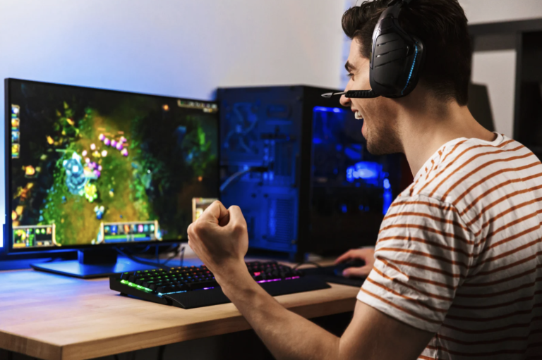 Person enjoying a video game on a computer while wearing a headset